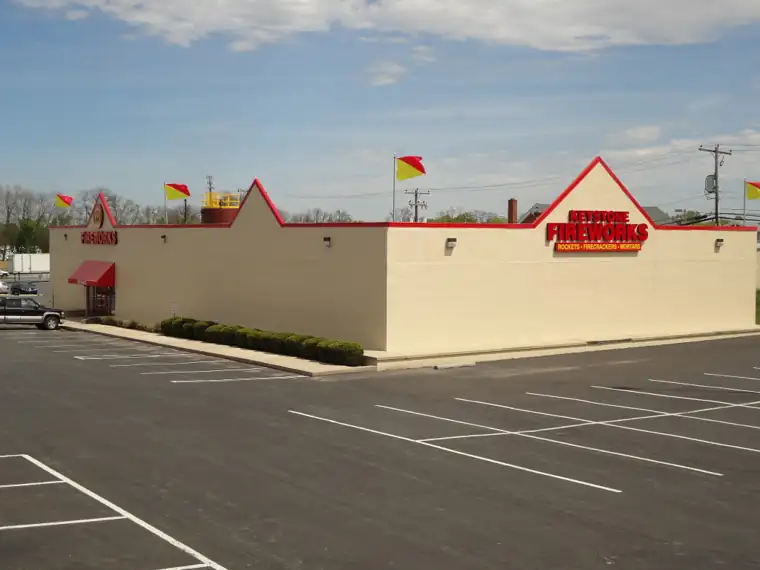 Keystone Lancaster building with red trim and a large parking lot