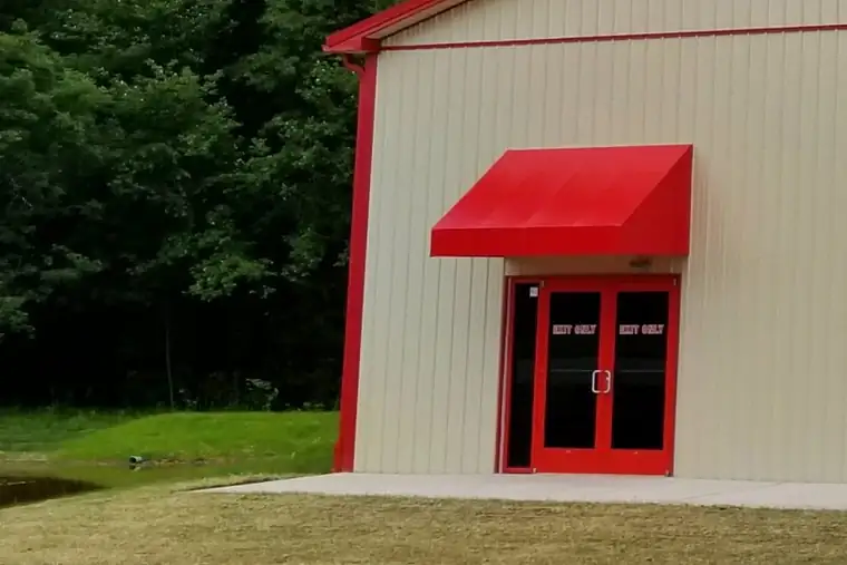 Side of the Keystone Nottingham building with a second door under a red awning